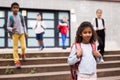 Curly mulatto tween girl walking to school campus after lessons Royalty Free Stock Photo