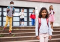 Curly mulatto tween girl walking to school campus after lessons Royalty Free Stock Photo