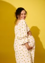 Curly multiethnic pregnant woman expecting a baby, smiling broadly looking at camera, isolated background. Childbearing