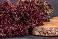 Curly purple lettuce and cut board.