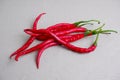 curly red chilies on white background