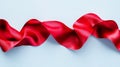 A curly red ribbon is situated on a white isolated background within the image Royalty Free Stock Photo