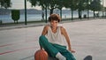 Curly sportsman sitting stadium zoom on. Basketball player relaxing portrait Royalty Free Stock Photo
