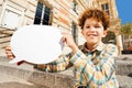 Curly teenage boy with white blanked speech bubble Royalty Free Stock Photo