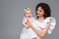 Curly woman holding cheerful baby girl Royalty Free Stock Photo