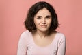 curly woman looking in camera with sarcastic expression Royalty Free Stock Photo