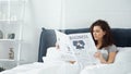 curly young woman reading business newspaper Royalty Free Stock Photo