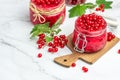 Currant jam with fresh red currants on a light background. Homemade jam. Glass jar with red currant jam. Preserved berry Royalty Free Stock Photo