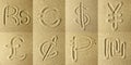 Currency abbreviations Written in the Sand Royalty Free Stock Photo