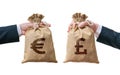 Currency exchange concept. Hands holds bags full of money - British pounds and Euro