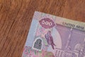 The Currency of the United Arab Emirates UAE - Close up of a purple five hundred Dirham note  on a brown table background. Money Royalty Free Stock Photo