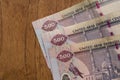 The Currency of the United Arab Emirates UAE - Close up of row of purple five hundred Dirham note  on a brown table background. Royalty Free Stock Photo