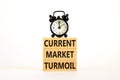 Current market turmoil symbol. Concept words Current market turmoil on wooden blocks on a beautiful white table white background. Royalty Free Stock Photo