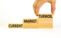 Current market turmoil symbol. Concept words Current market turmoil on wooden blocks on a beautiful white table white background. Royalty Free Stock Photo