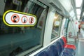 15Dec21 Singapore: Train & decal of masked person with index finger over mouth & `no talking on mobile-with masks` notices on left