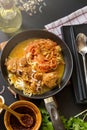 Curried Noodle Soup with spicy coconut milk and beef In a black Royalty Free Stock Photo