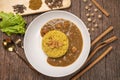 Curry chicken with yellow rice on plate over wooden background, Chicken with basmati rice