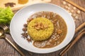 Curry chicken with yellow rice on plate over wooden background, Chicken with basmati rice Royalty Free Stock Photo