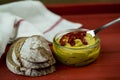 Curry hummus in a glass bowl with rustic bread