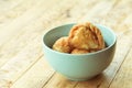 Curry puff pastry in cyan vintage bowl put on old table with copy-space