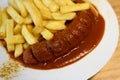 Curry Sausage or Currywurst with French Fries Royalty Free Stock Photo