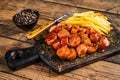 Curry wurst Sausages with French fries on a wooden board. wooden background. Top view