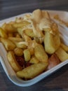 currywurst with fries into a cup. traditional german food to go with dip at corona times Royalty Free Stock Photo