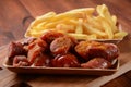 Currywurst Sausages with French fries. Traditional German currywurst  sausages Royalty Free Stock Photo