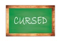 CURSED text written on green school board