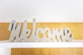 Cursive welcome sign on the shelf