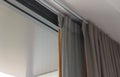 Curtain rail with gray curtain, tulle and wooden Handle. Curtain decoration and interior design in living room or bedroom