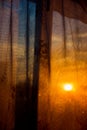 Through the curtain shines the setting sun Royalty Free Stock Photo