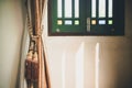 Curtain is tied with classic style tassels beside the vintage wi Royalty Free Stock Photo