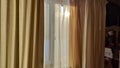 Curtain with tulle on the window. The interior of the room with draped curtains