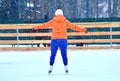 Curvaceous woman on a skating rink