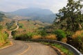 Curve asphalt road going down and up to hill along with mountains and clouds blue sky background at Phu Lanka Forest Park, Phayao Royalty Free Stock Photo