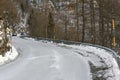Curve of a frozen mountain road in winter
