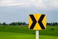 Curve marker traffic signs on grass field background Royalty Free Stock Photo