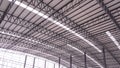 Curve metal roof beam structure with aluminium corrugated steel roof and skylights inside of large industrial factory building