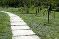 The curve the path of concrete tiles on a Sunny day. Park with a long road along the trees. Park with a long road along the trees. Royalty Free Stock Photo