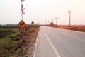 Curve road on countryside with two traffic sign in Thailand. Royalty Free Stock Photo