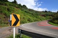 Curve road sign on down hill blue sky background Royalty Free Stock Photo