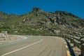 Curve roadway passing through rocky landscape