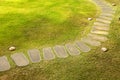 Curve stone walkway on grass field in garden Royalty Free Stock Photo