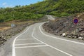 Curved asphalt road over the hot volcanic lava at Reunion island, France. Royalty Free Stock Photo