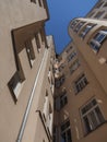 Curved back facade of an old tenement house against the sky