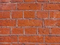 Curved brickwork of red orange geometric horizontal bricks bonded with cement grout between square stones. Wall Royalty Free Stock Photo