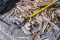 Curved crowbar on construction waste debris, wood chips on old concrete floor, demolished room, close up view