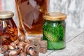 A curved crystal decanter with homemade moonshine stands on a wooden stand