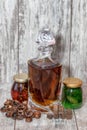 A curved crystal decanter with homemade moonshine stands on a wooden stand